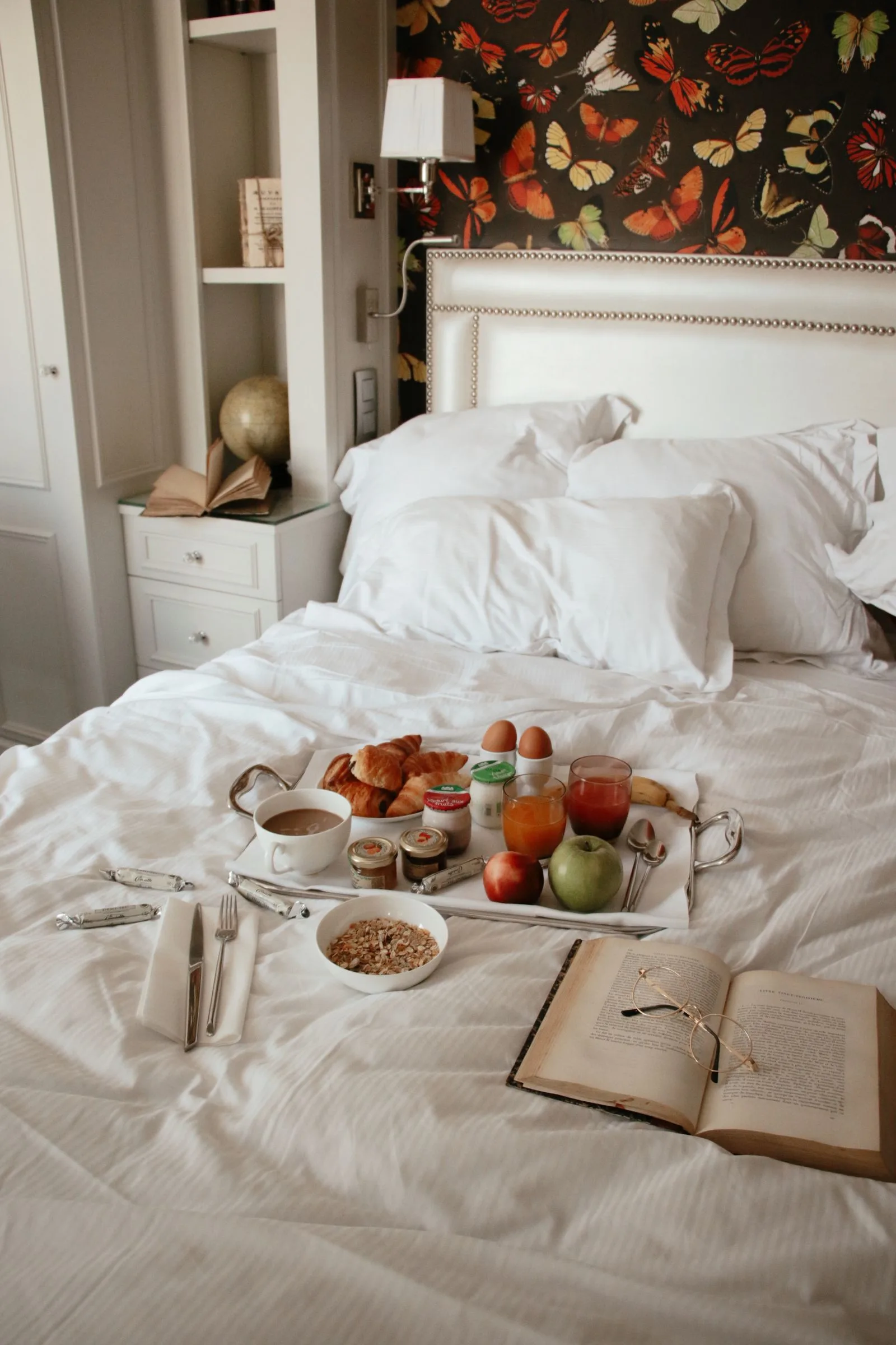 A cozy breakfast in bed with croissants and coffee