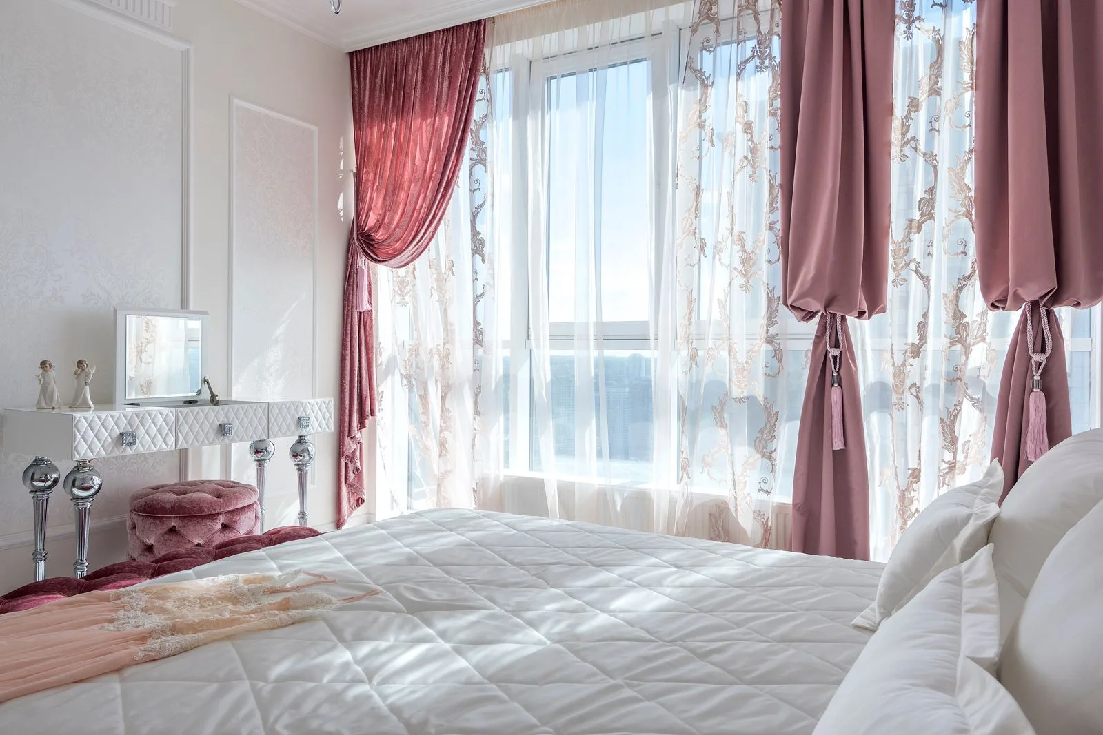 Bright elegant bedroom with chic decor and comfortable bed