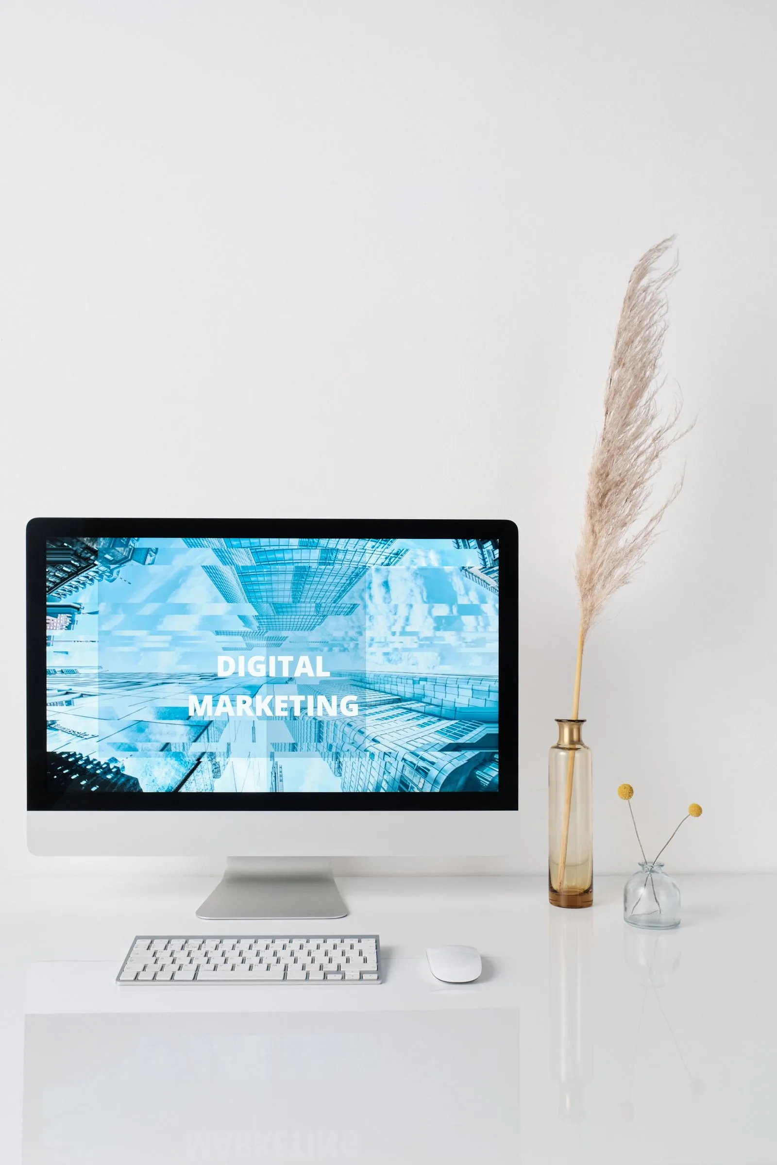 Modern workspace with digital marketing graphics displayed on a monitor