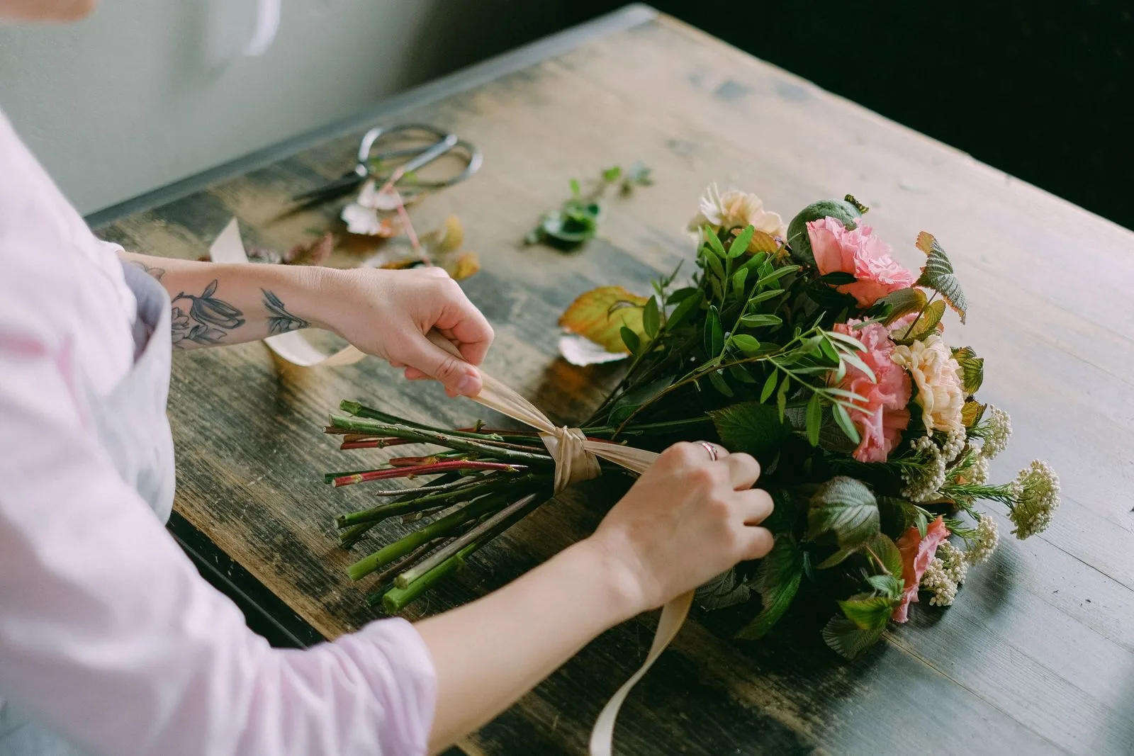 Demo: Flower Shop Website Concept 2 Florist arranging a bouquet of fresh flowers indoors