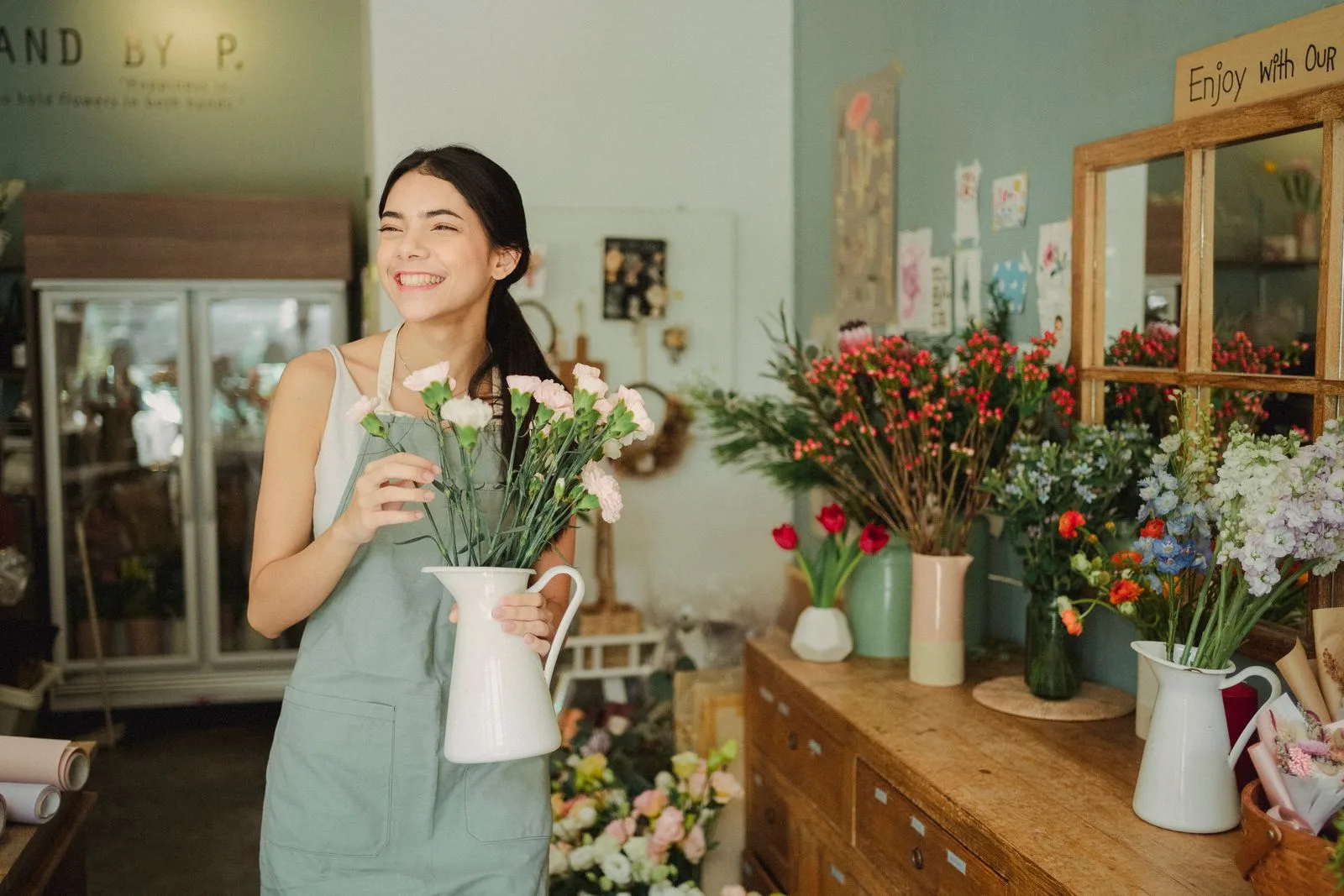 A joyful florist arranging fresh blooms in a flower shop