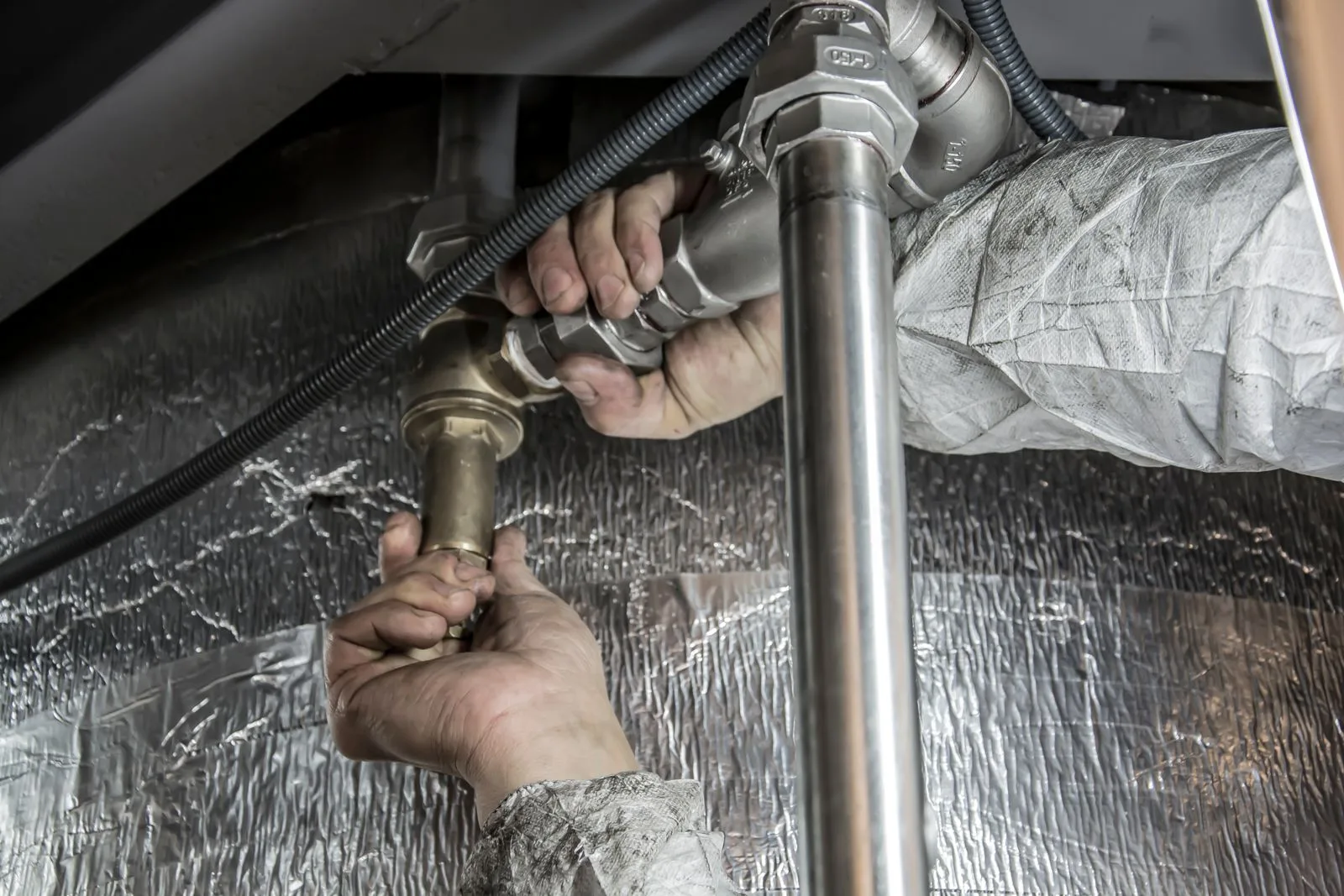 Plumber installing steel pipe fittings