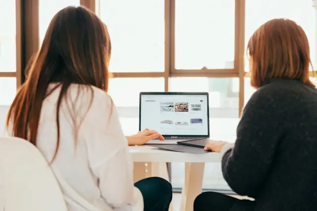 Two people browsing an online product catalogue together on a laptop